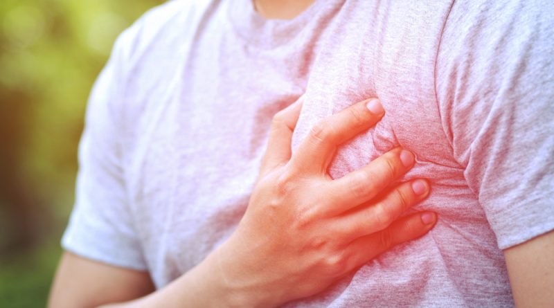 Man having chest pain heart attack causes body shock disease sofa living room have colic acid flows back chest health care concept