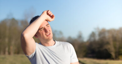 young-man-athlete-received-sun-heat-stroke-headache-guy-holds-his-head-with-his-hands-protects-himself-from-sun-outdoors