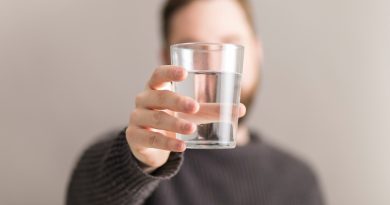 Man Showing Glass Water