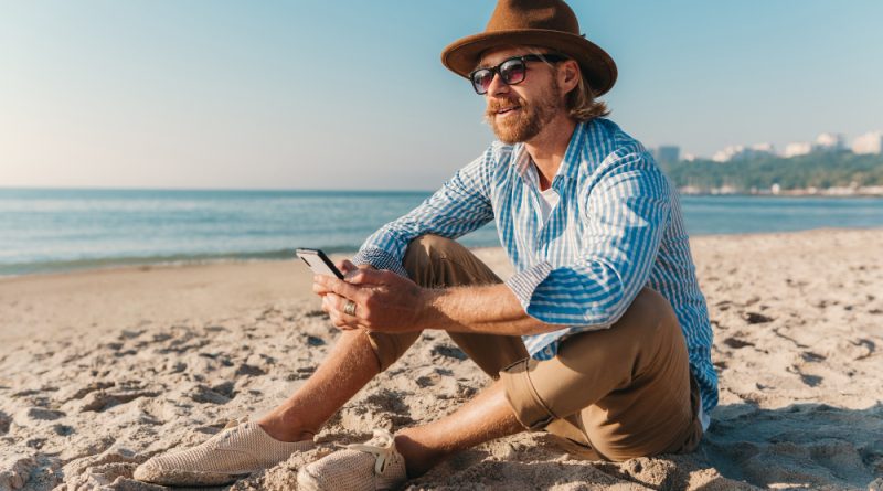 Young Attractive Hipster Man Sitting Beach By Sea Summer Vacation