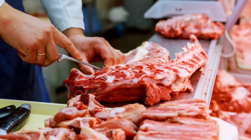 Cropped Image Male Butcher Cutting Raw Meat With Knife Counter Shop