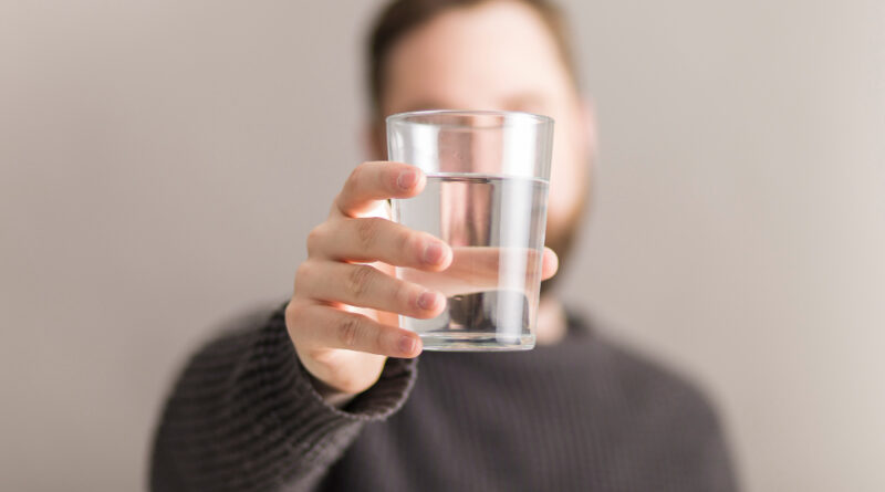 man-showing-glass-water