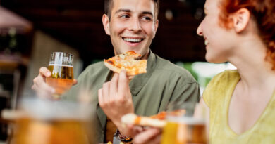 Happy Couple Talking While Eating Pizza Drinking Beer Pub