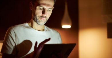 Focused Man Using Tablet Night