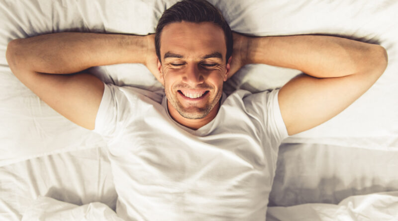 Top view handsome man smiling while lying