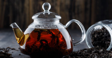 black-tea-with-dry-tea-teapot-wooden-surface-side-view