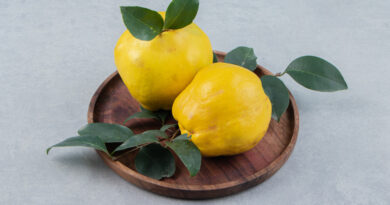 Two Quinces With Leaves Wooden Plate