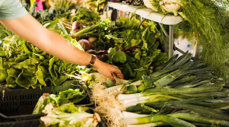 Male Consumer S Hand Choosing Green Fresh Vegetable Market Stall