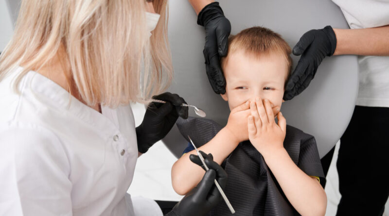 Little boy dentist s chair during examination process