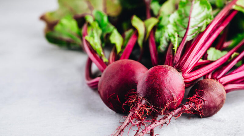 Bunch fresh raw organic beets with leaves gray stone background (1)