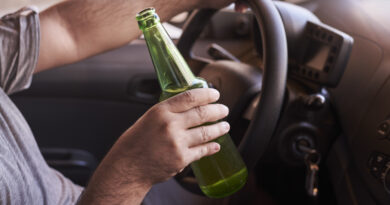 bottle-beer-man-s-hands-driving-car-during-daytime