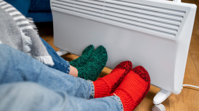 Close Up People With Legs Near Heater