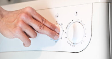 Person Switches Temperature Program Knobs Washing Machine Before Wash Closeup