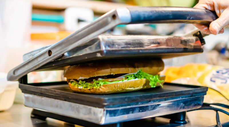 Employed Cook Putting Sandwich Toaster Grill Toasting Restaurant