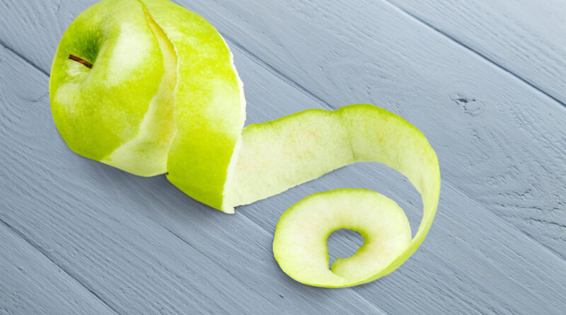 Apple Peeled With Twisting Skin Against White