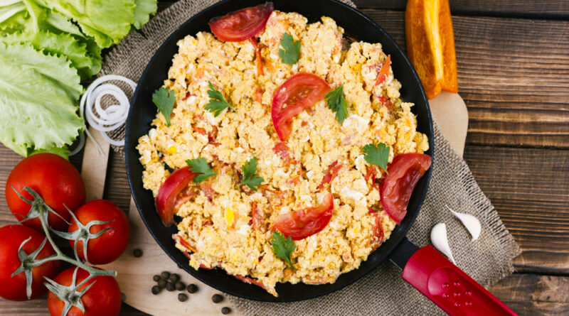 Flat lay scrambled eggs with tomatoes
