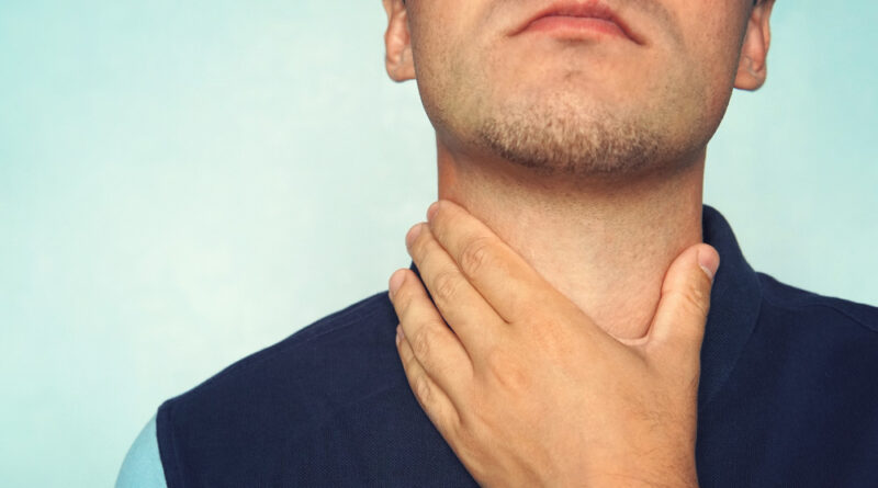 Young Man Having Sore Throat Touching His Neck Wearing Loose T Shirt Against Light Blue Background Hard Swallow Nodule Thyroid Gland