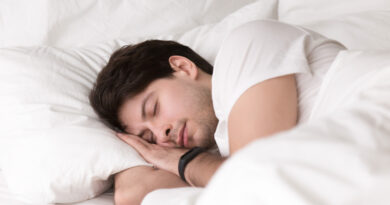 young-guy-sleeping-bed-wearing-smartwatch-sleep-tracker