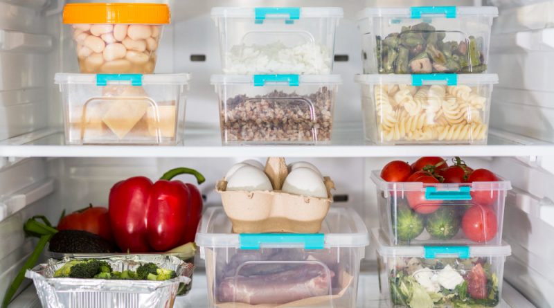 open-fridge-with-plastic-food-containers-vegetables