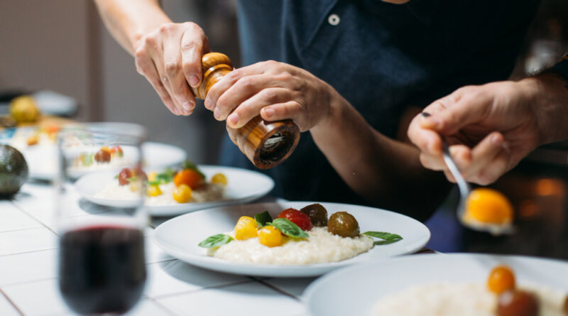 Chef serves dish home dinner party