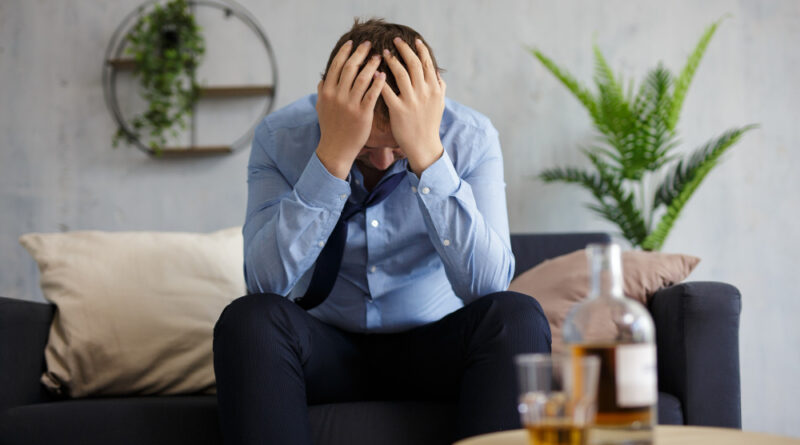 Alcoholism depression crisis bankruptcy concept depressed businessman drinking alcohol home office