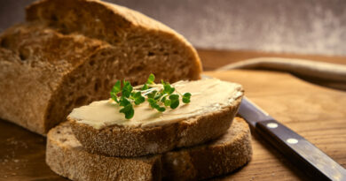 artisan-sliced-toast-bread-with-butter-with-microgreen-broccoli-wooden-cutting-board-with-knife