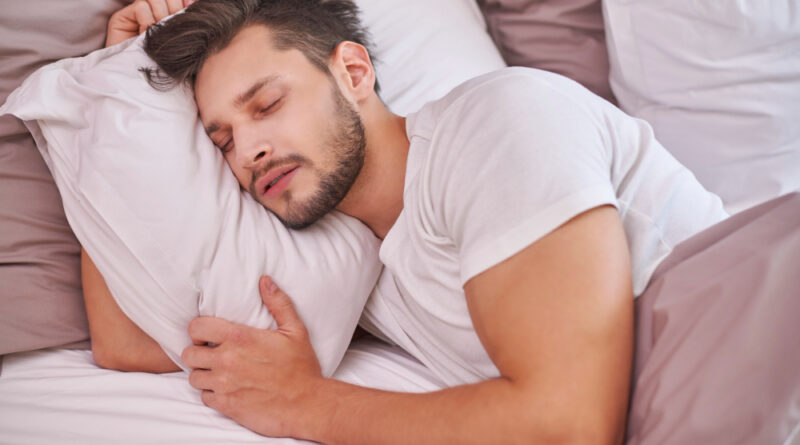 Exhausted man sleeping his bed