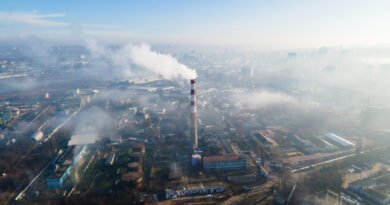 aerial-drone-view-chisinau-thermal-station-with-smoke-coming-out-tube-buildings-roads-fog-air-moldova