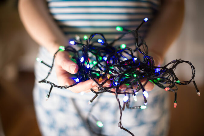 woman-holding-christmas-lights