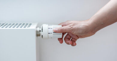 woman-s-hand-adjusting-thermostat-valve