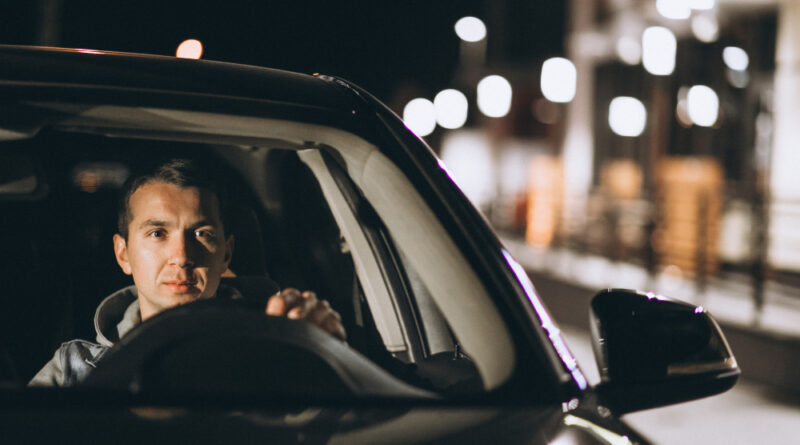Young man driving his car night time