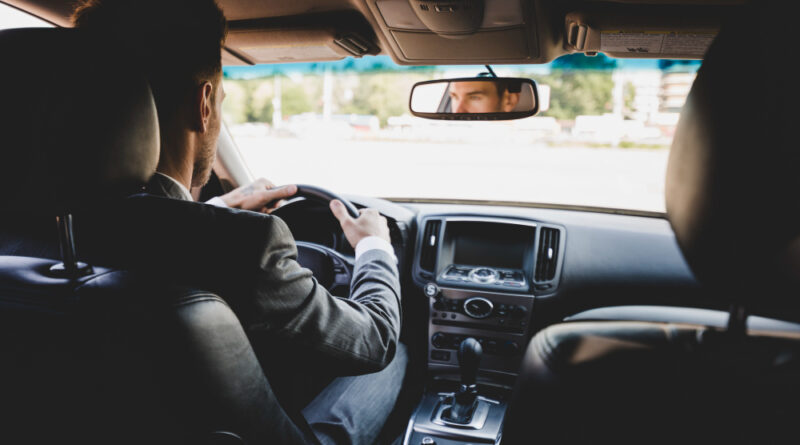 Rear View Businessman Driving Car