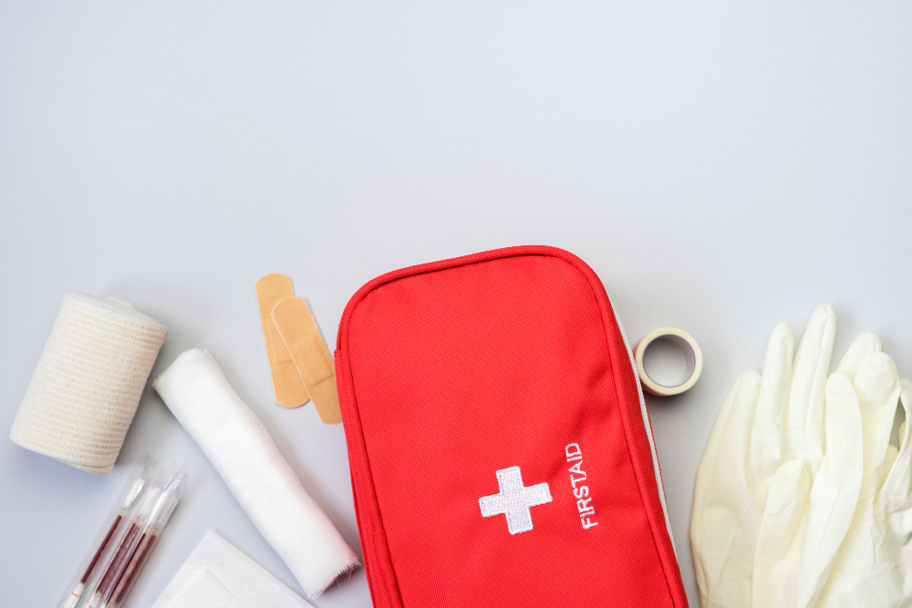 First Aid Kit Red Bag With Medical Equipment Medications Trauma Injuries Treatment Top View Flat Lay Gray Background Copy Space