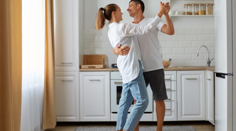 Full Length Portrait Happy Smiling Husband Wife Dancing Together Home Light Room With Kitchen Set Fridge Window Background Happy Couple