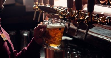 Bartender Fills Beer Mug From Beer Tap