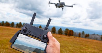 landscaping-drone-young-man-holds-his-hand-quadrocopter-control-panel-with-monitor-image-mountains