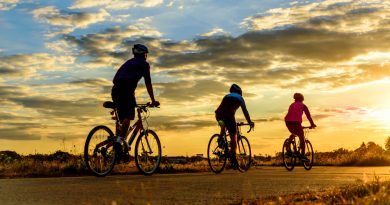 group-men-ride-bike-sunset