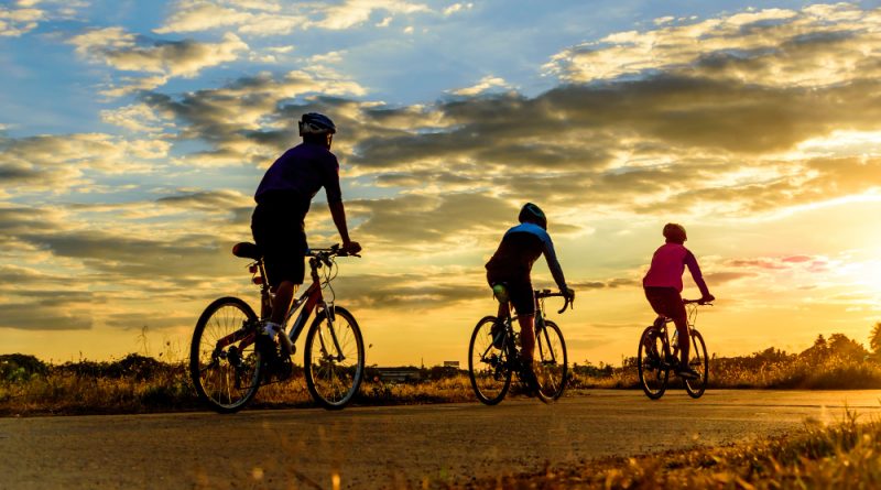 Group Men Ride Bike Sunset