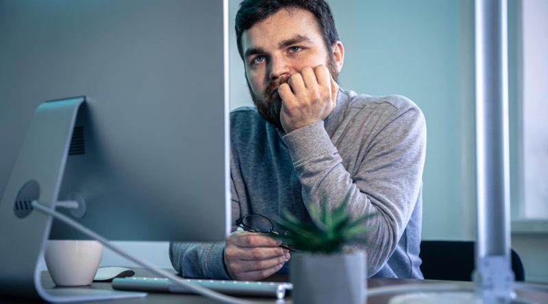 Tired Bearded Man Looks Computer Screen