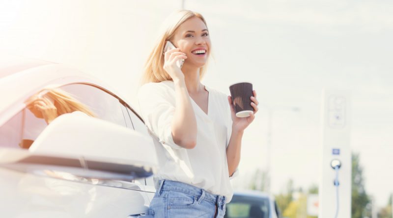 young-happy-female-driver-talking-phone