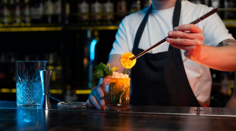 Bartender making delicious refreshing cocktail